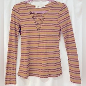 Red, yellow, and purple striped tan long sleeve shirt with low cut neckline